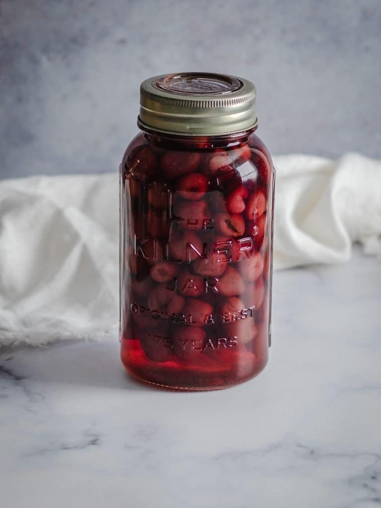 A Kilner preserving jar full of cheeries in a sugar syrup. Image by Emma Lee -  The Irishman's Wife
