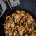 slow cooked beef stroganoff with black pepper parpadelle in a cast iron frypan