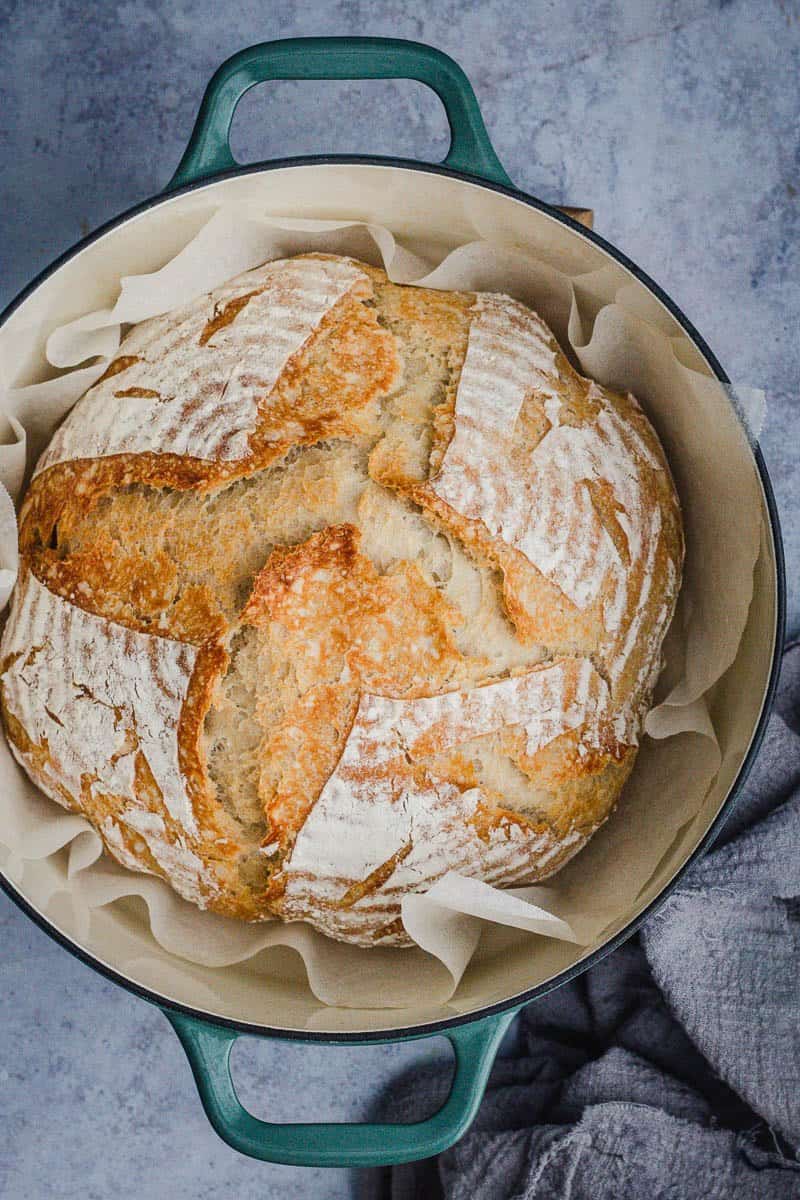 cold start baked loaf of sourdough in a green cast iron pot