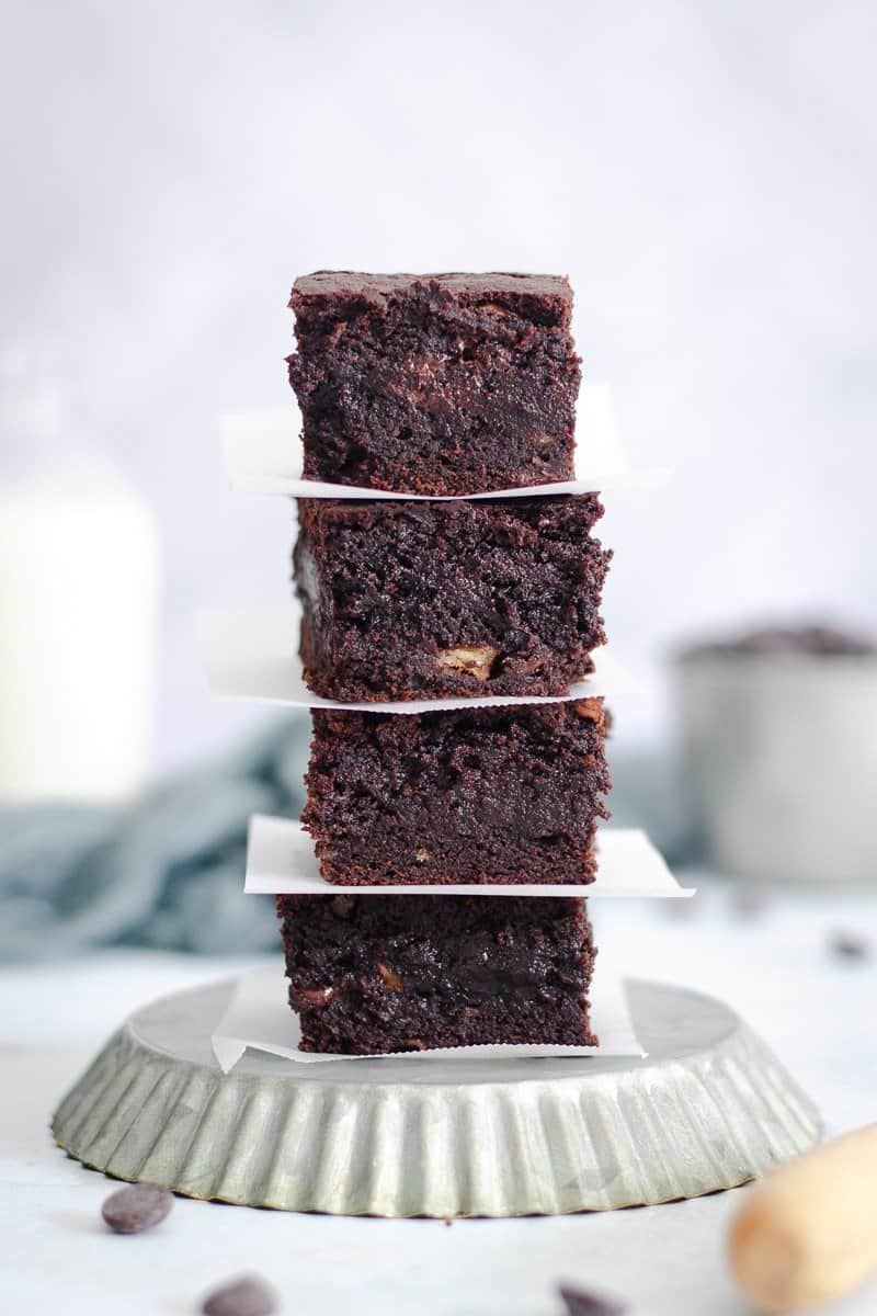 a stack of chocolate chip banana brownies on top of an upside down tart tin