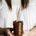 Woman holding a jar of balsamic fig jam with both hands