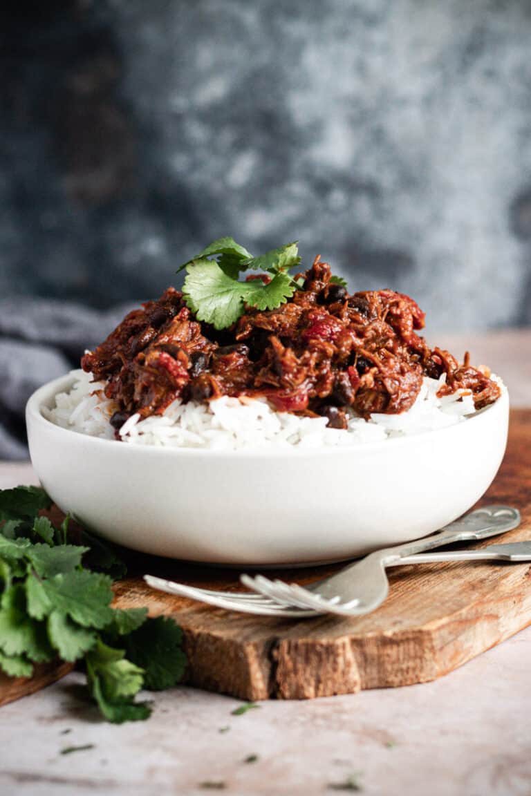 a bowl of slow-cooked Mexican beef cheeks on a bed of rice in a bowl