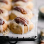 row after row of maple pecan shortbread cookies on a black baking rack.