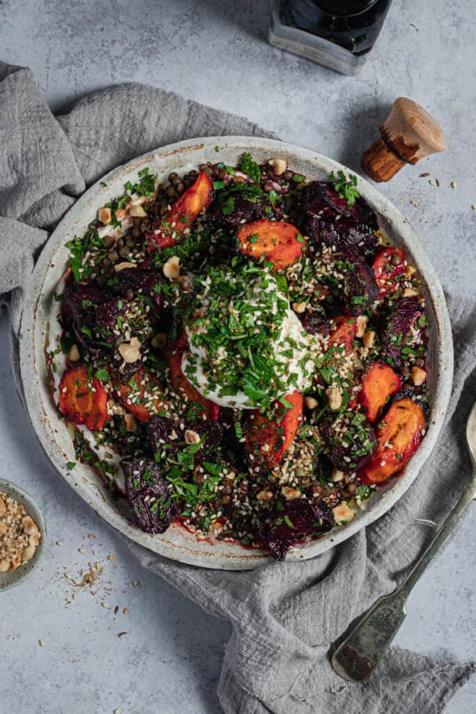 close up of a plate of roasted balsamic beetroot and carrot salad with labneh