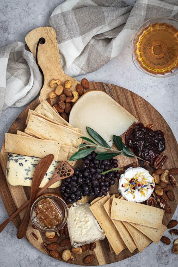 A Valentines cheeseboard for two alongside a glass of Pimms