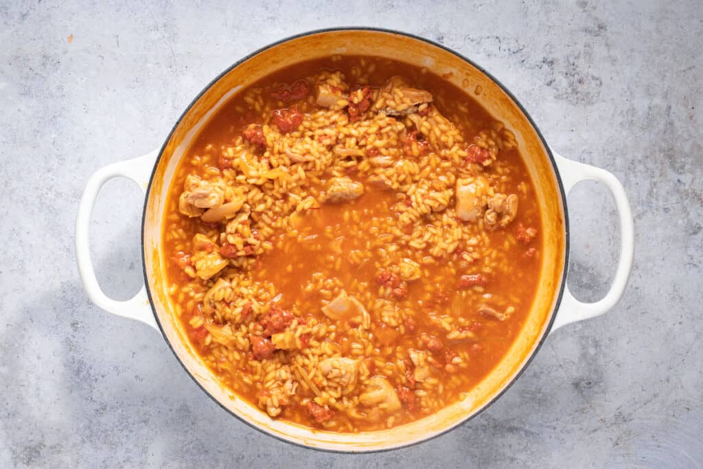 Chicken stock is continually added to the pan while simmering.