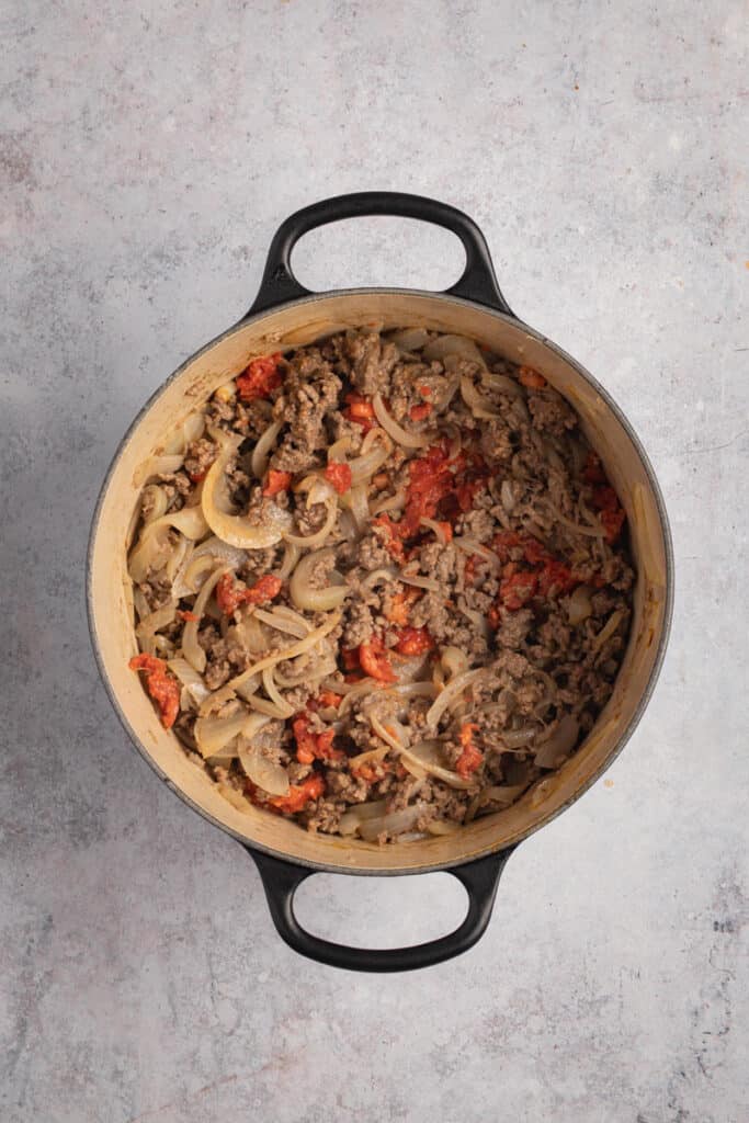 Ground beef and chorizo are added to the pan.