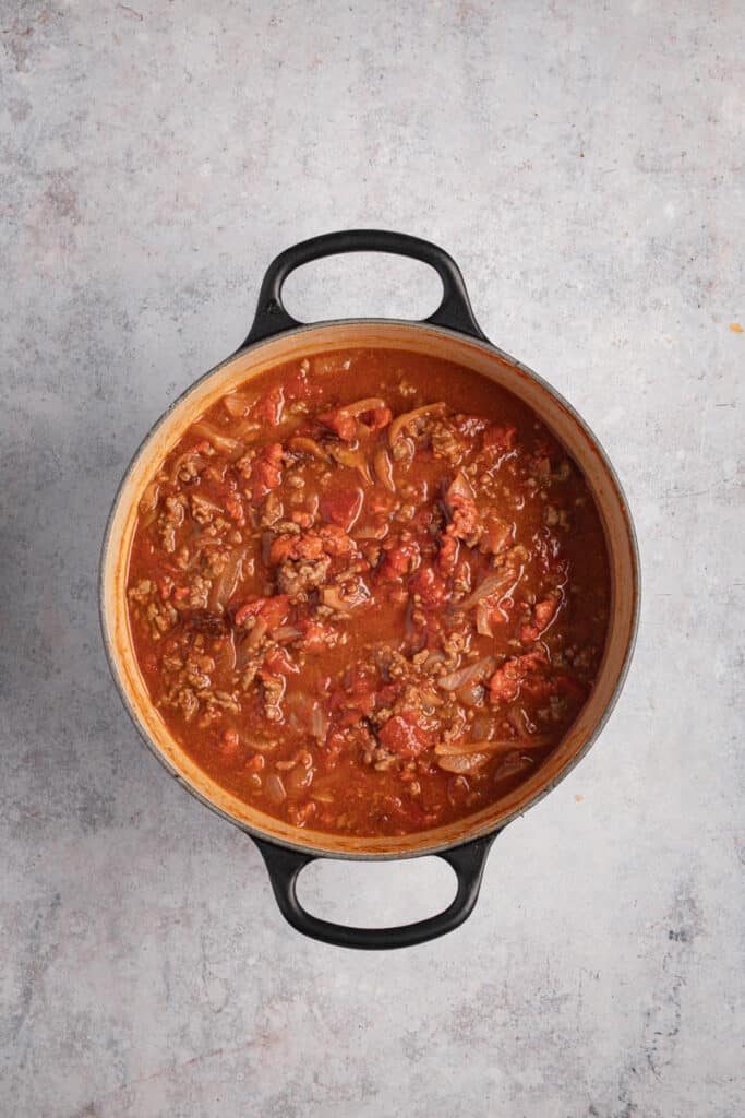 All the ingredients (except beans) for chili con carne in the Dutch oven ready to go into the oven.