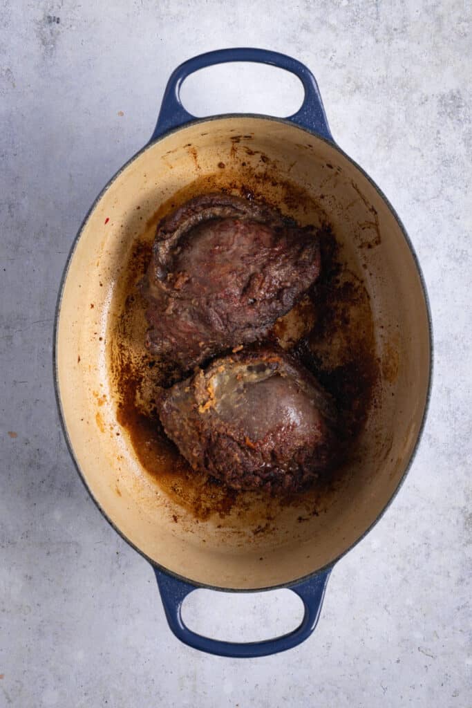 Beef Cheeks being browned and sealed in an oval casserole.
