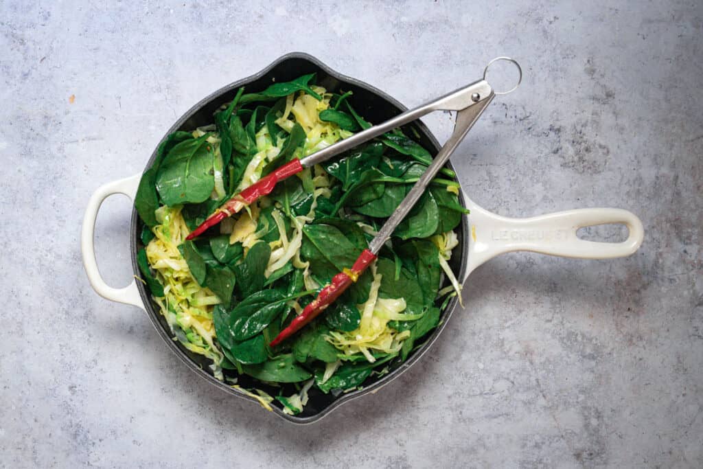 All the greens sauteing in a little butter in a frypan.