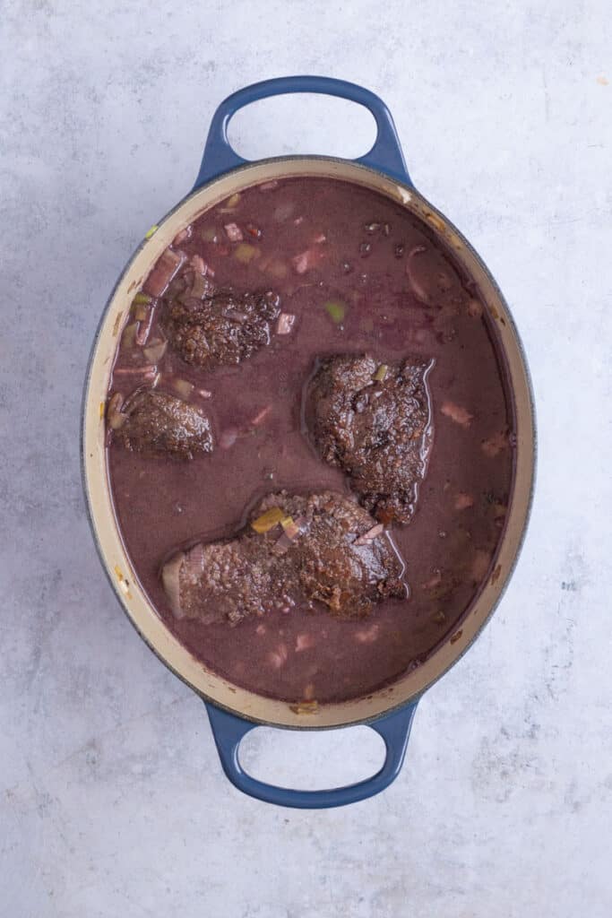 The beef cheeks and all remaining ingredients, except mushrooms are added to the pot.