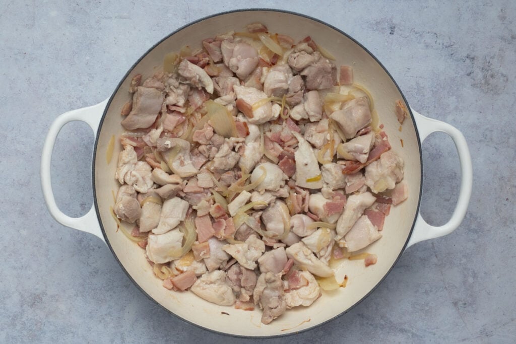 Bacon, chicken and garlic is added and sauteed until just cooked.