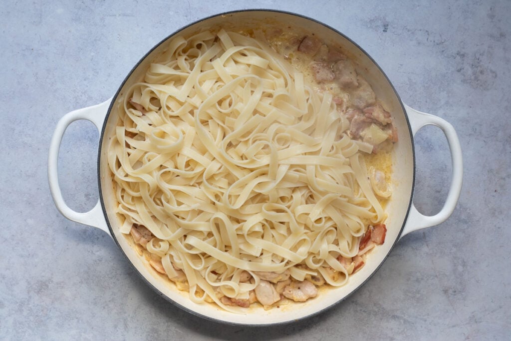 Add the fettuccine to the pan.