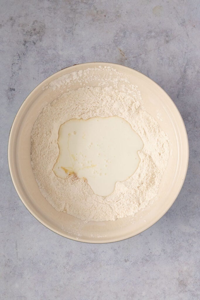 The buttermilk mixture is added to the bowl of dry ingredients.