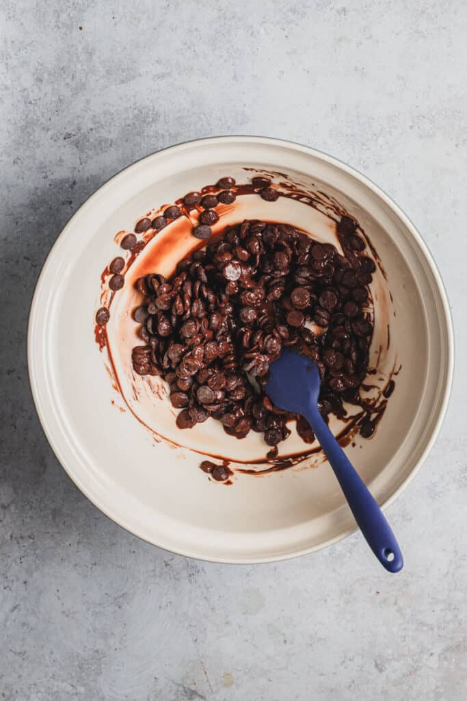 Dark chocolate melting in a large ceramic bowl. 