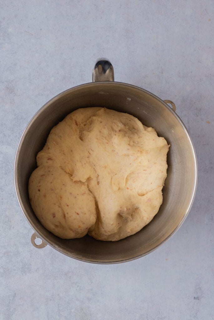 Dough in a metal bowl after the first proof.