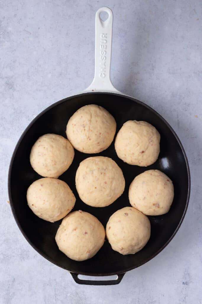 Dough divided and shaped and put in a greased skillet ready for the second rise.