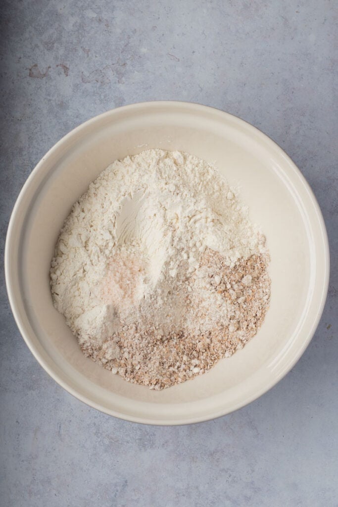 All the ingredients for brown bread in a mixing bowl.