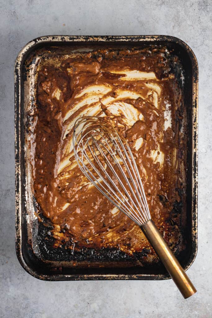 Flour has been added and a whisk is making a roux with flour.