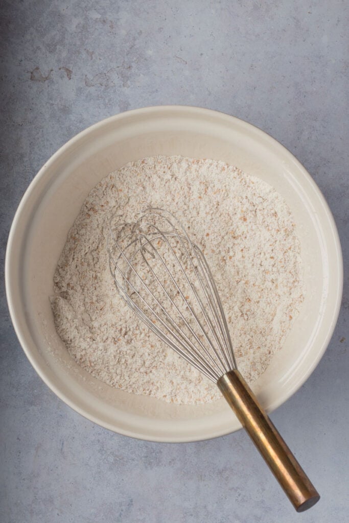 A whisk has whisked all the dry ingredients together. 