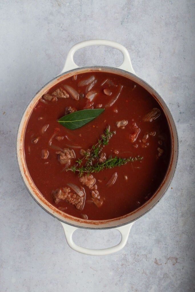 The red beef ragu with all it's ingredients together in a pot before it goes into the oven.