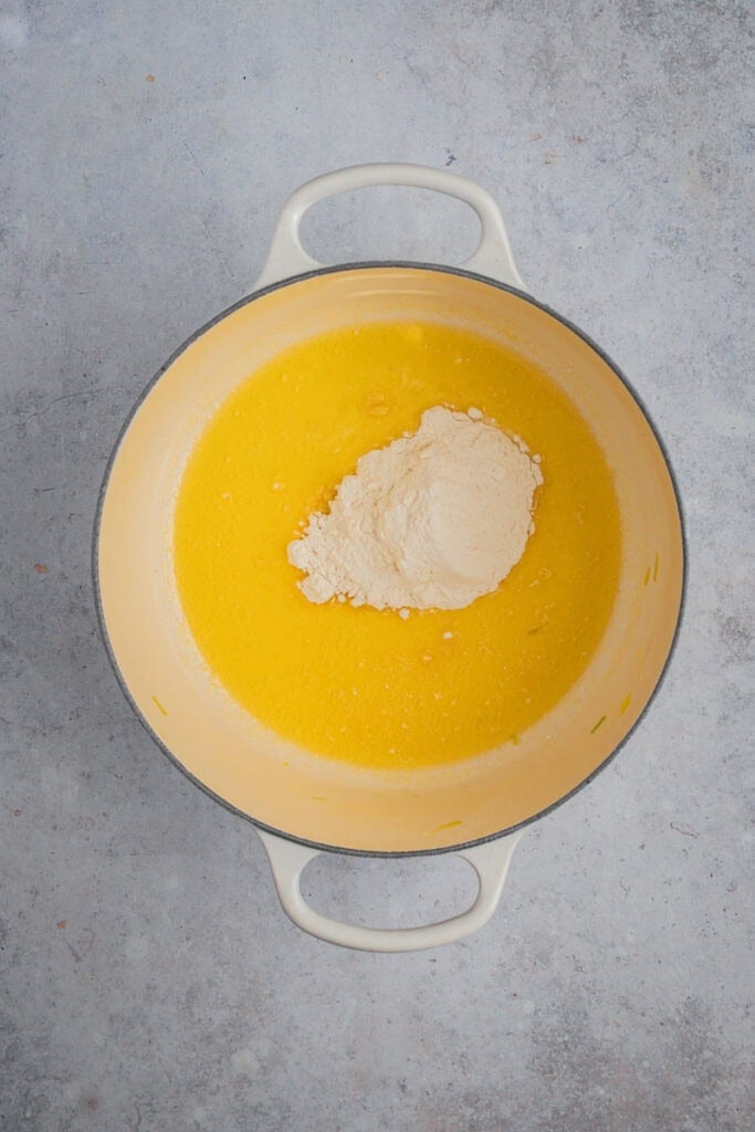 Plain flour is added to the pot of melted butter.
