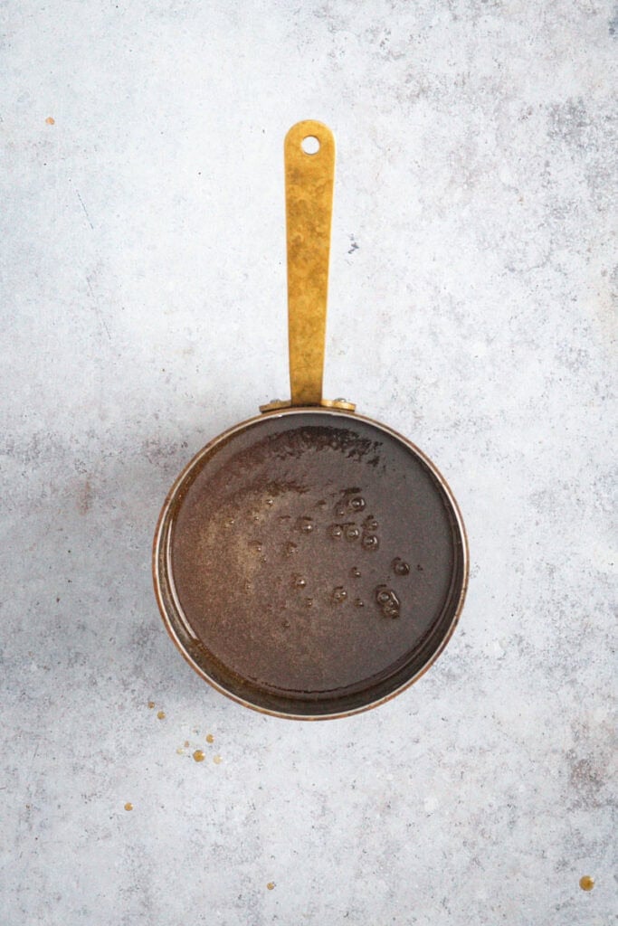 The finished dark brown butterscotch sauce ready to eat.