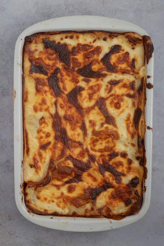 A cheesy golden lasagna baked and just out of the oven.