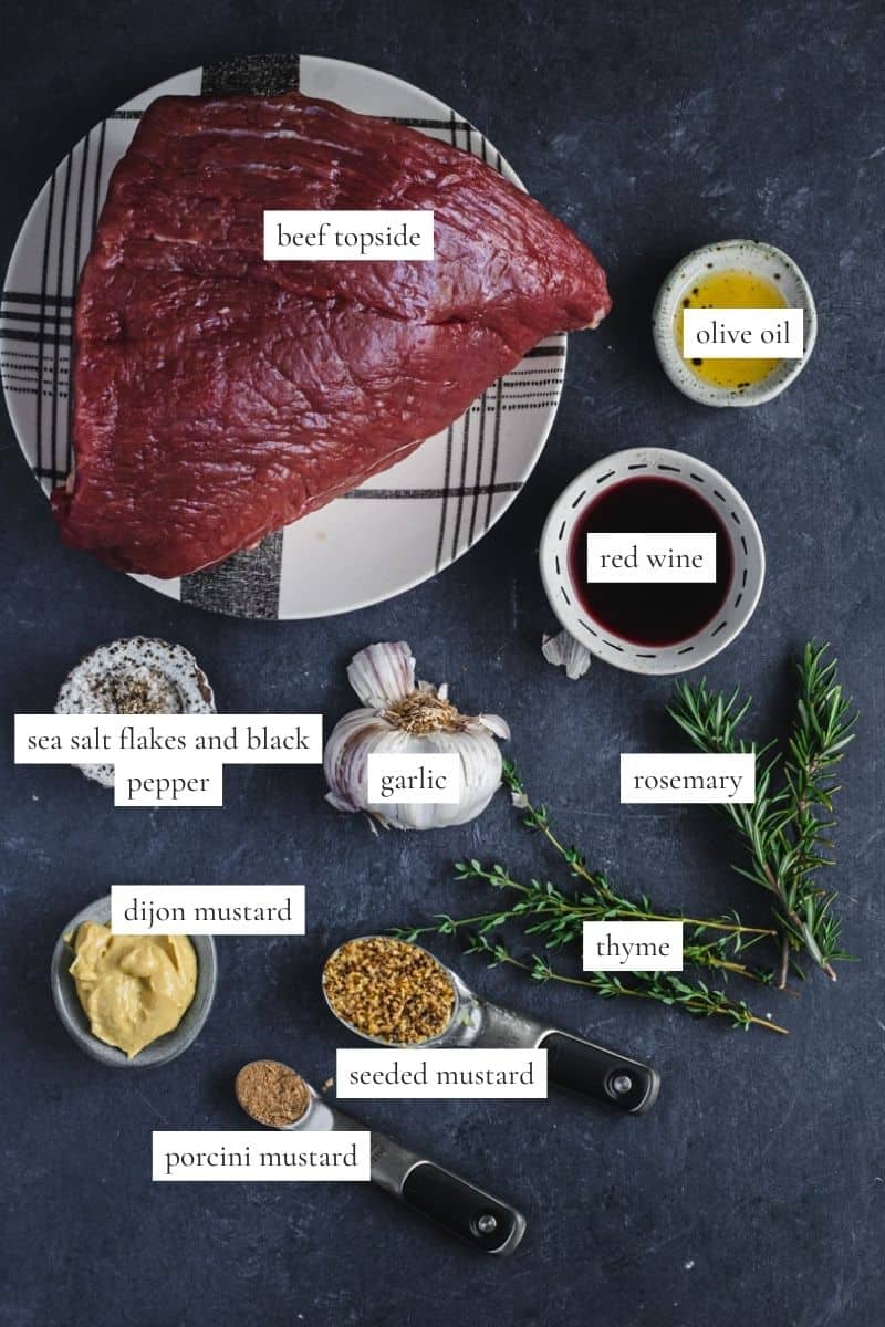 All the ingredients you need to make beef topside roast with garlic and rosemary.