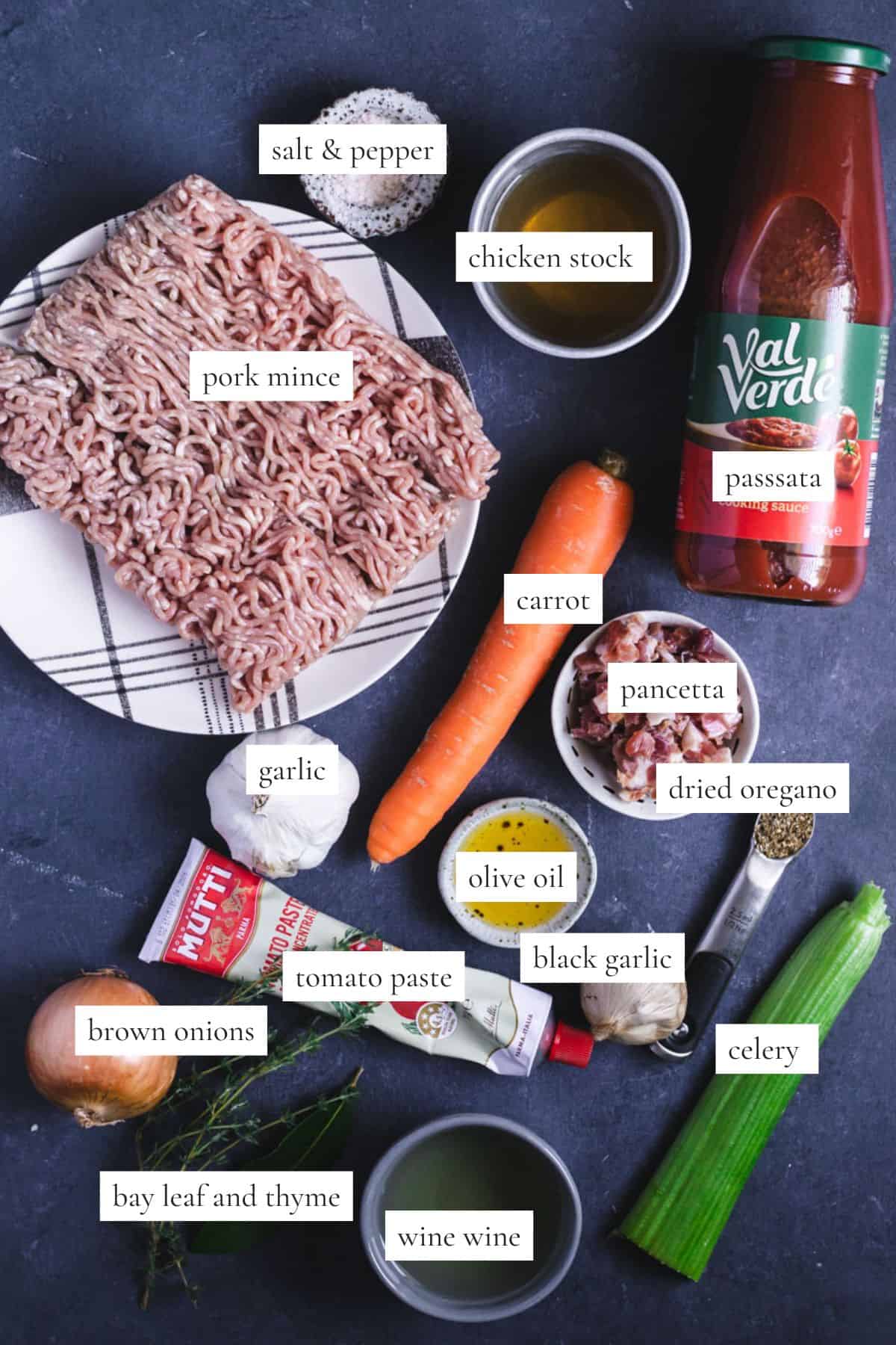 All the ingredients you need to slow cook a pork bolognese in the oven.