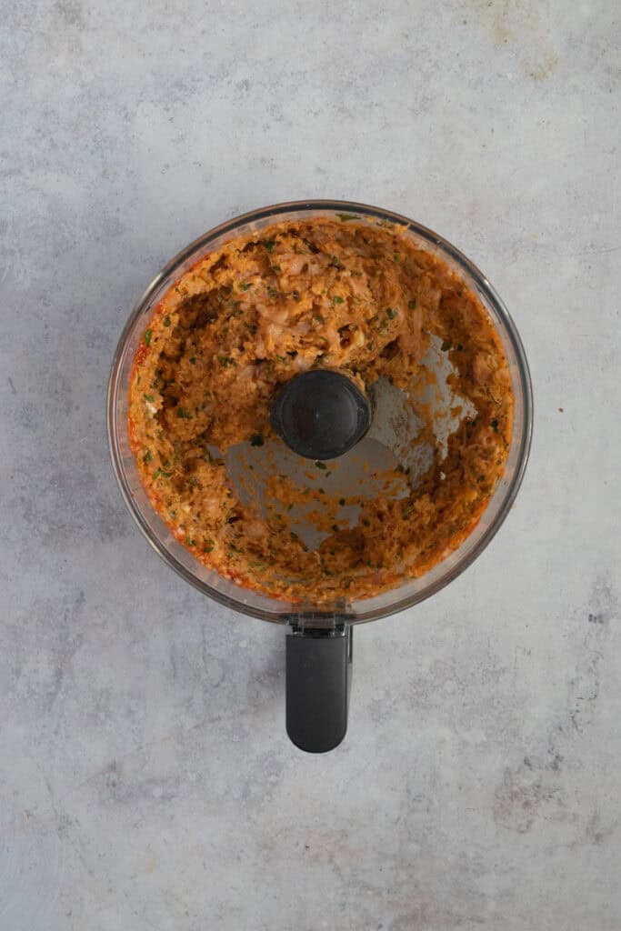 The minced and mixed chicken meatball mixture in a bowl.