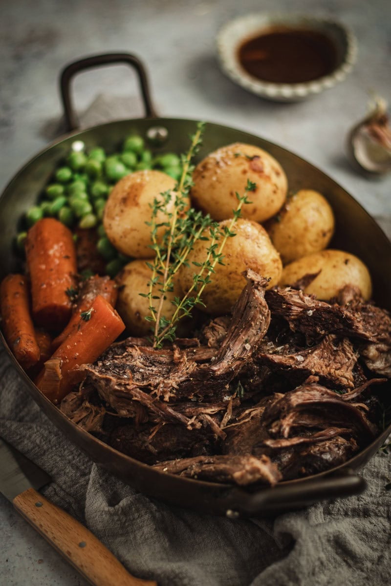 Slow cooked beef roast with carrots and potatoes.
