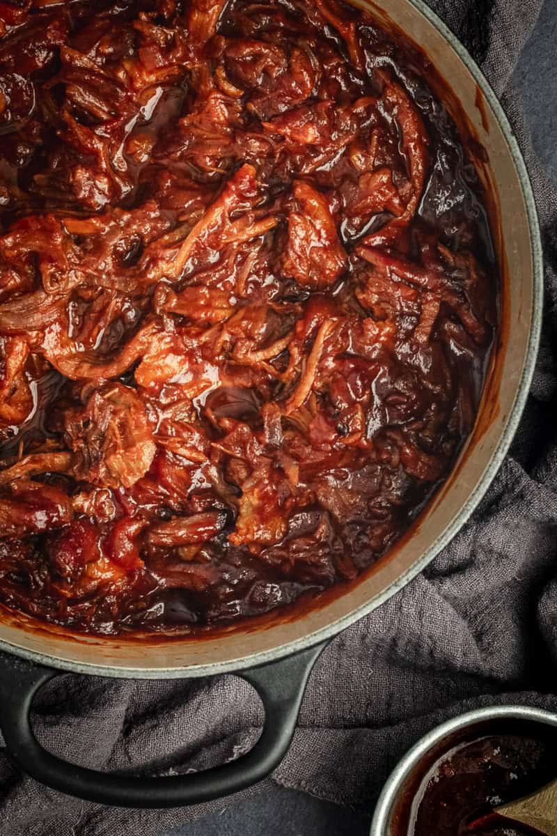 Close up of a Dutch oven of BBQ pulled pork.