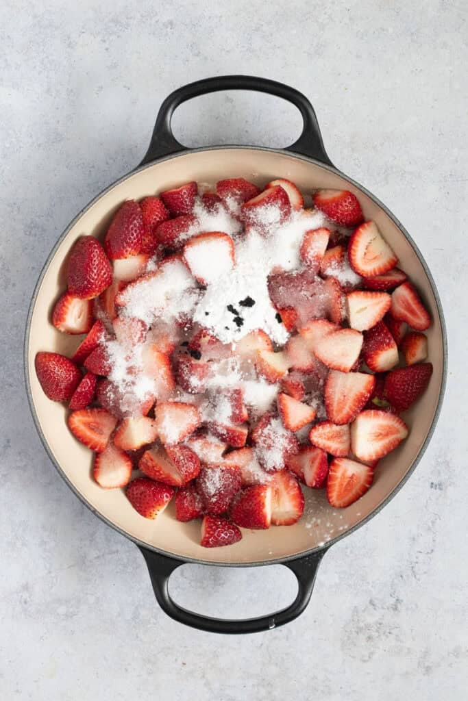 The strawberries, sugar, cornflour and vanilla bean seeds in a shallow Dutch oven.