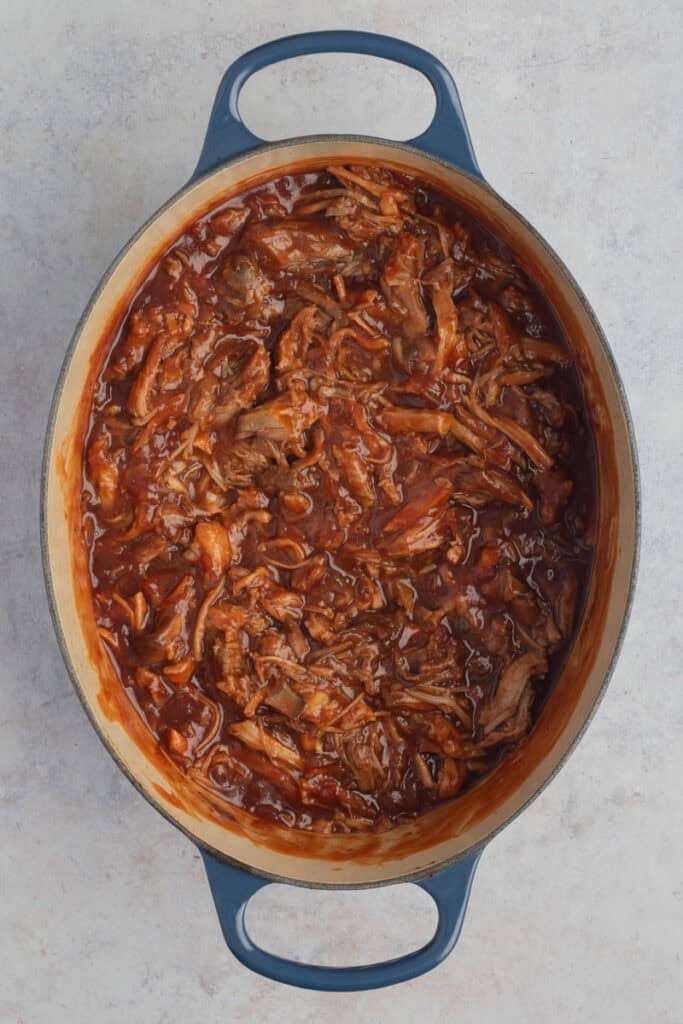 The finished BBQ pulled pork in a Le Creuset oval casserole.