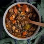 A black Le Cresuet dutch oven with a beef stew in it.