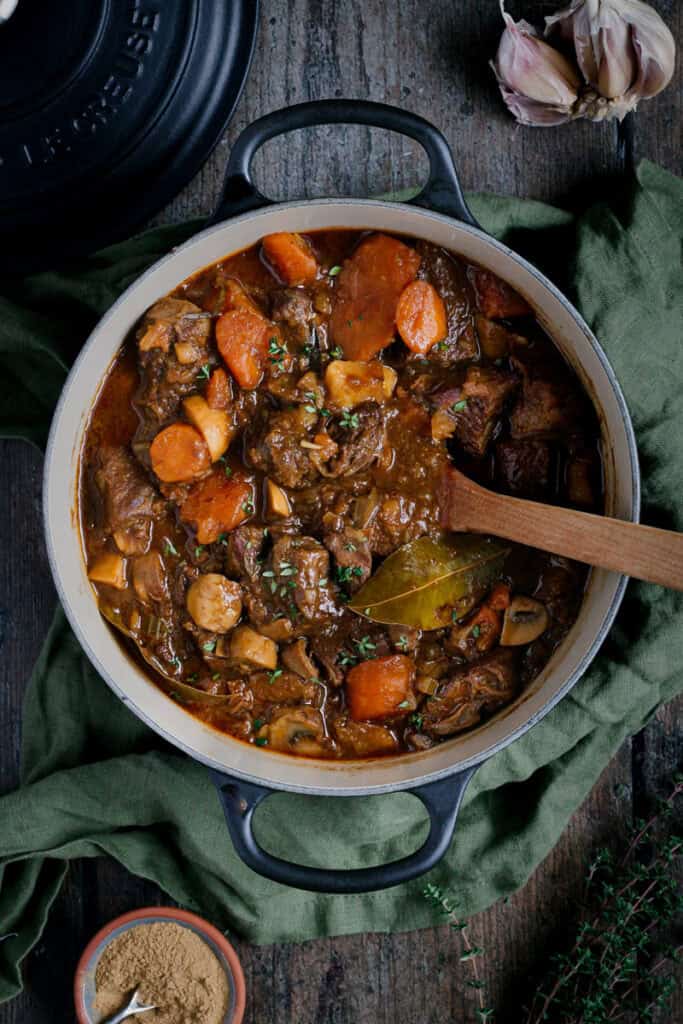 A black Le Cresuet dutch oven with a beef stew in it.