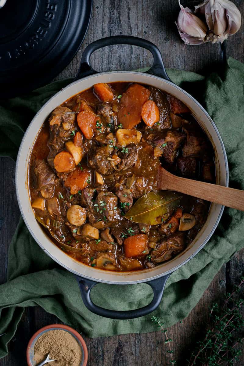 A black Le Cresuet dutch oven with a beef stew in it.