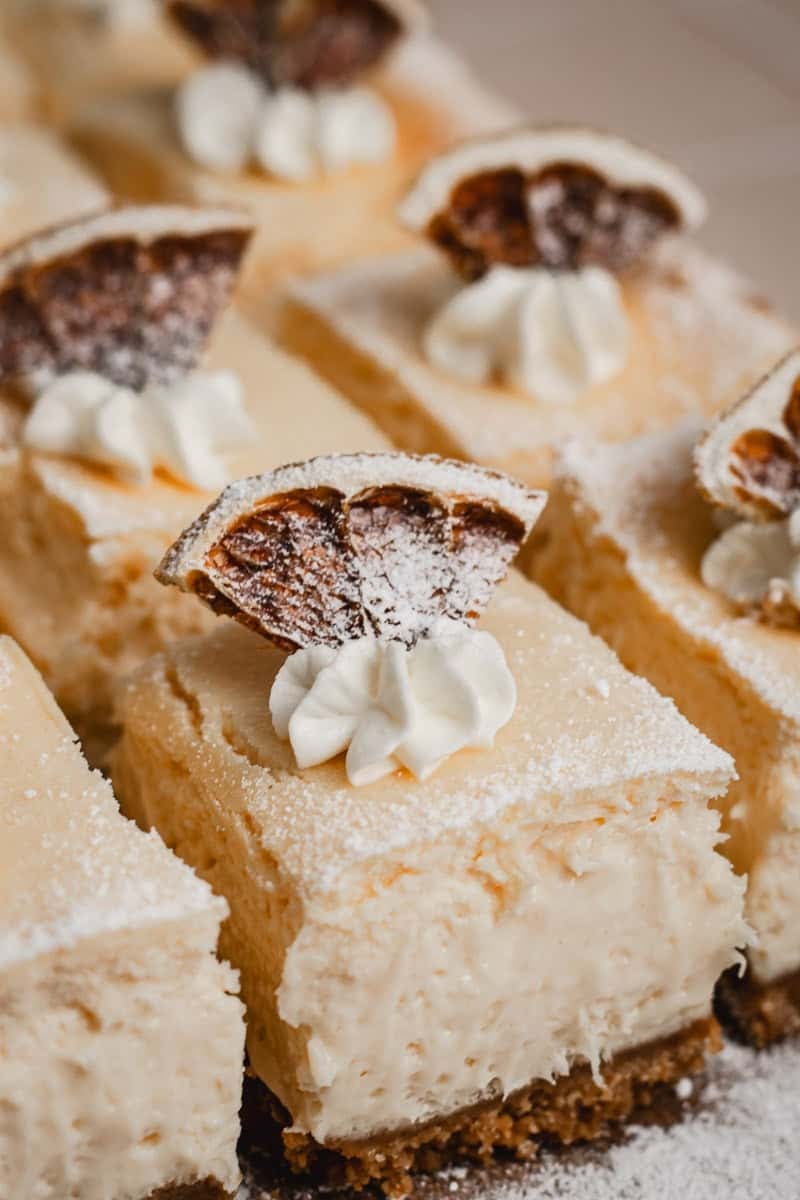 Close up of a tray of lemon curd cheesecake squares.